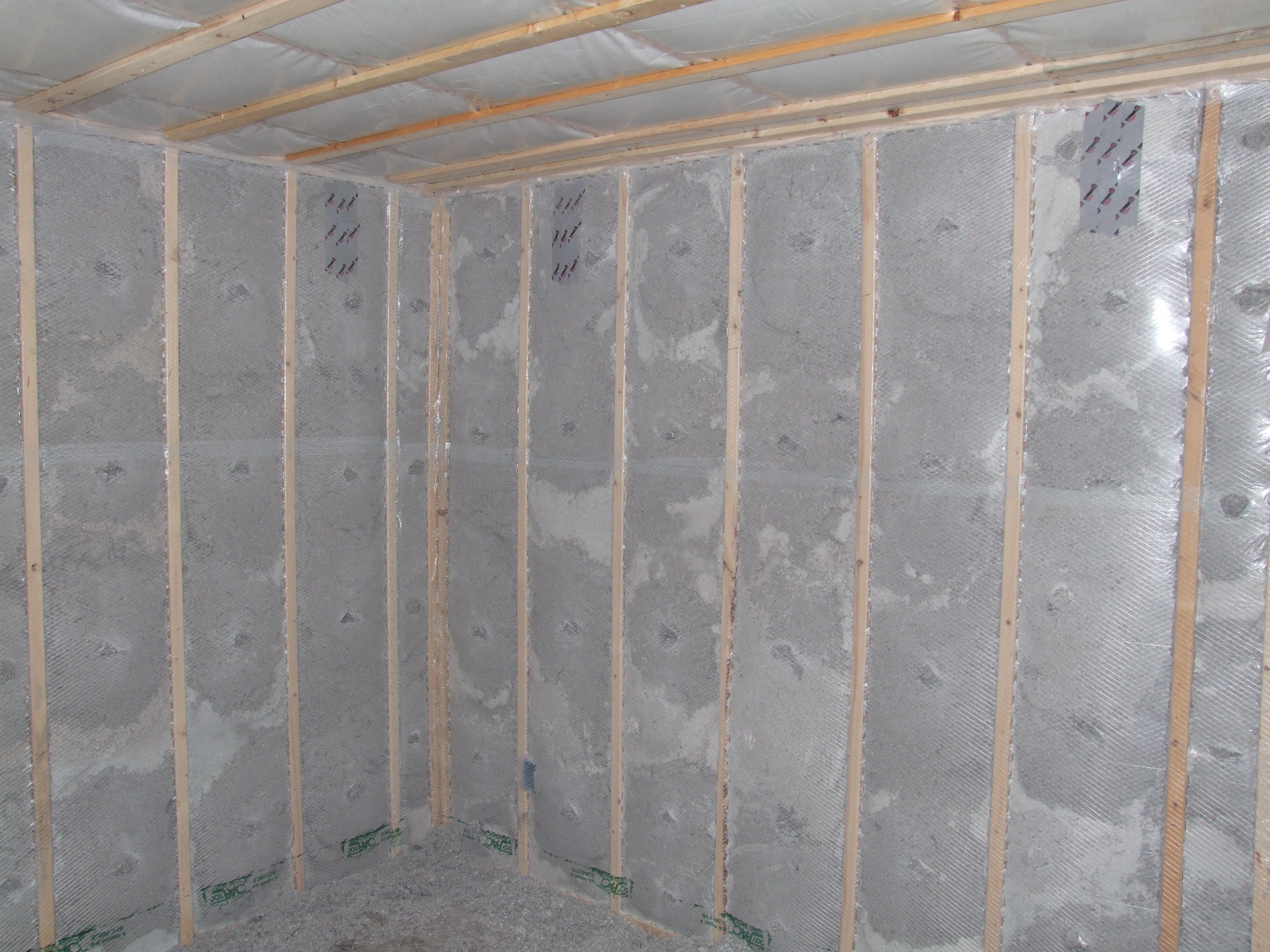 Blown cellulose insulation completely fills the netted wall and ceiling cavities 
