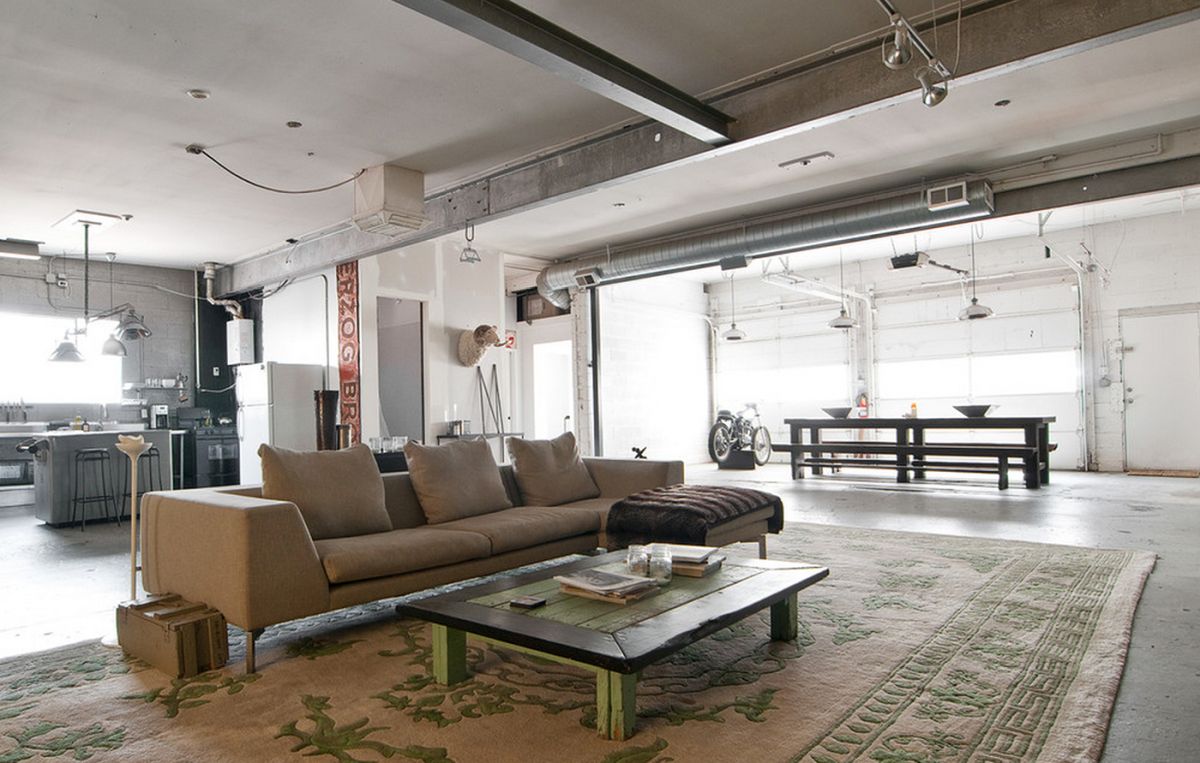 Exposed ductwork and pipes complement the concrete elements of this loft.