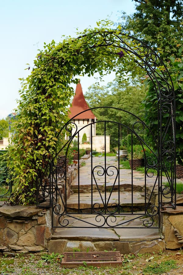 Arched iron gateway. Decorative arched iron gateway to a garden royalty free stock image