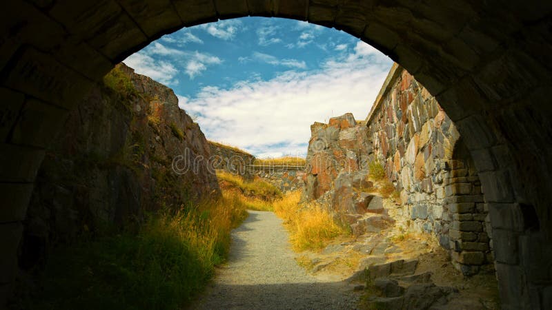 Arched stone passage through an old shore wall in Helsinki royalty free stock images
