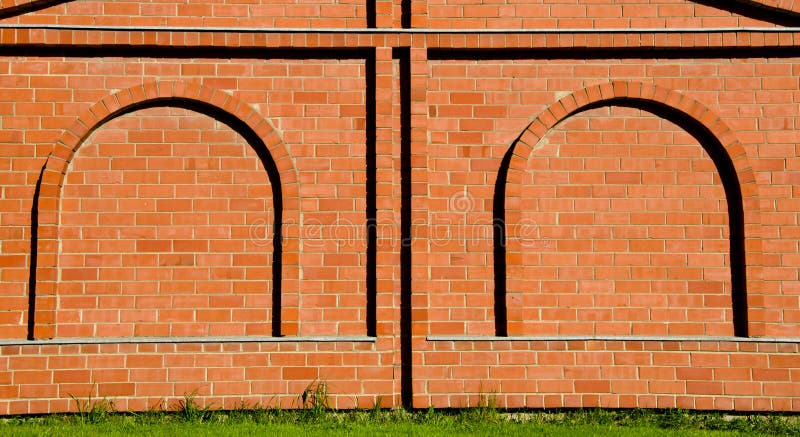 Background decorative brick wall arch imitation. Background of decorative red brick wall with arch imitation royalty free stock image