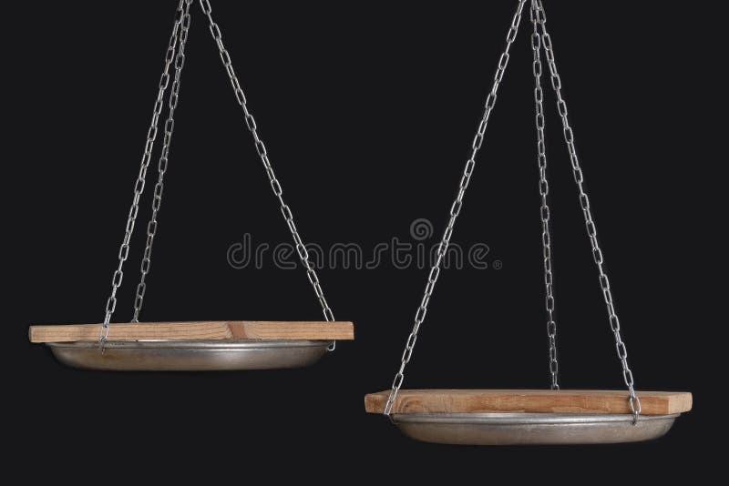 Balance scales and wooden coasters on black background, close up. Copy space. Balance scales and wooden coasters on black background close up. Copy space stock photos
