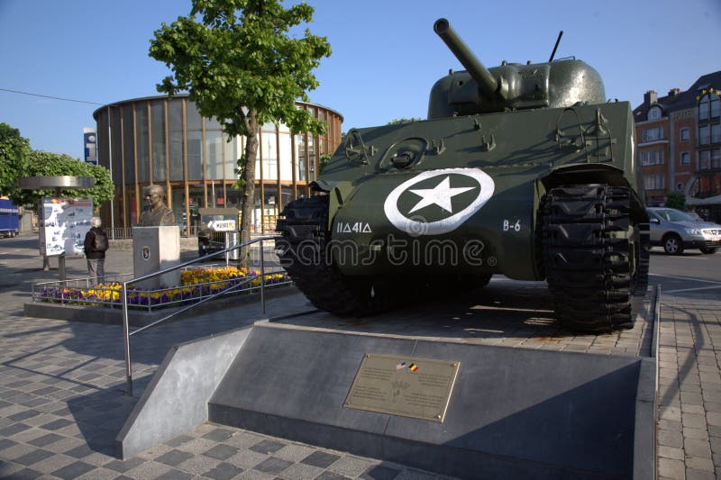 Bastogne Belgium. Original WW2 Sherman tank on a plinth. WW2 Sherman tank in original livery freshly painted on a stone plinth in the centre of the town stock photo