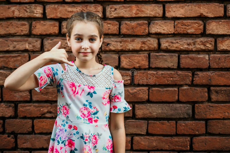 Beautiful teenage girl, on a background of a brick wall, emotional portrait royalty free stock image