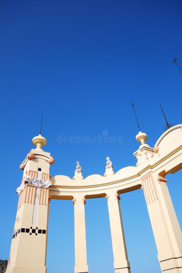 Beautiful Italian artwork. A view of the art and details of a beautiful stone arch or gateway against a cloudless blue sky royalty free stock images