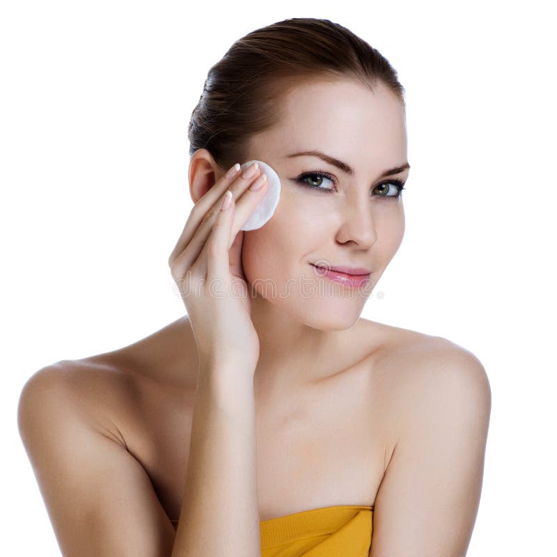 Beauty young woman applying face foundation stock photos