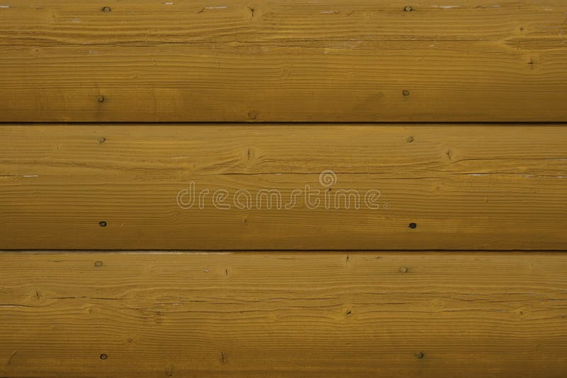 Quarter pine log siding with a yellow stained finish royalty free stock photo