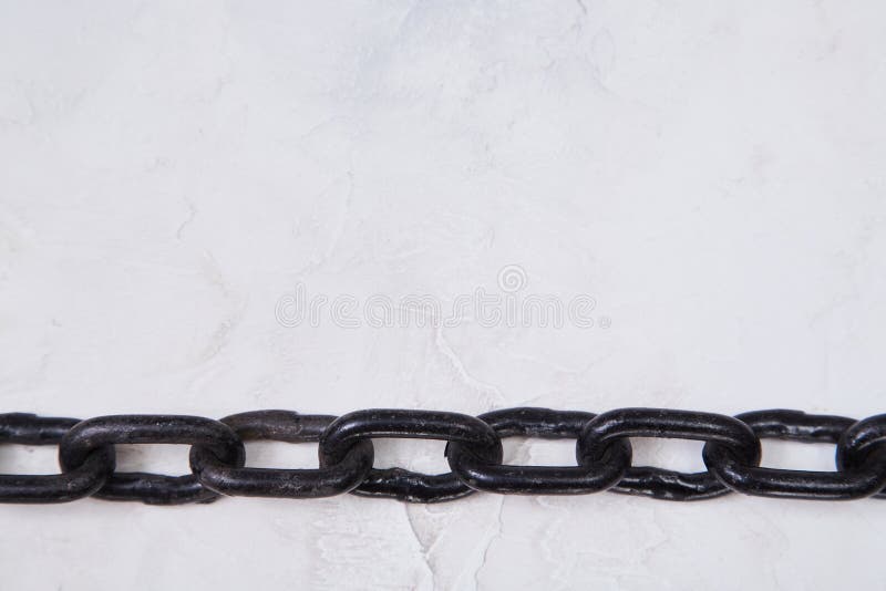 Black metal chain isolated on white textured background. Connected links for fastening or securing objects, copy space.  stock photos