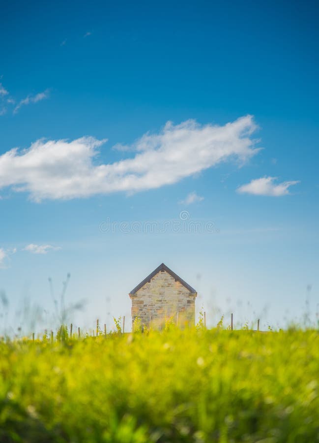 A brick cottage among an evening meadow royalty free stock photos