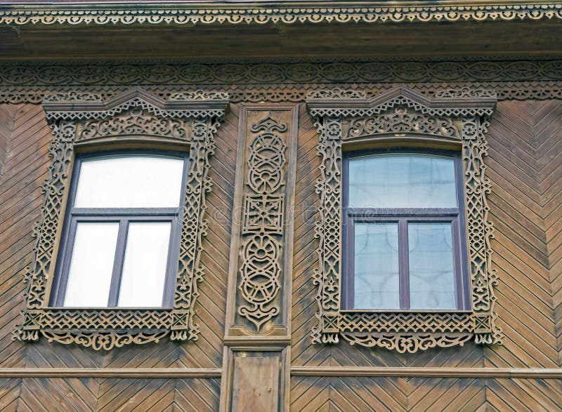 Carved platbands on Windows of the old house stock photos