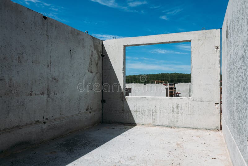 Concrete reinforced concrete blocks from which the house is built at the construction site stock images