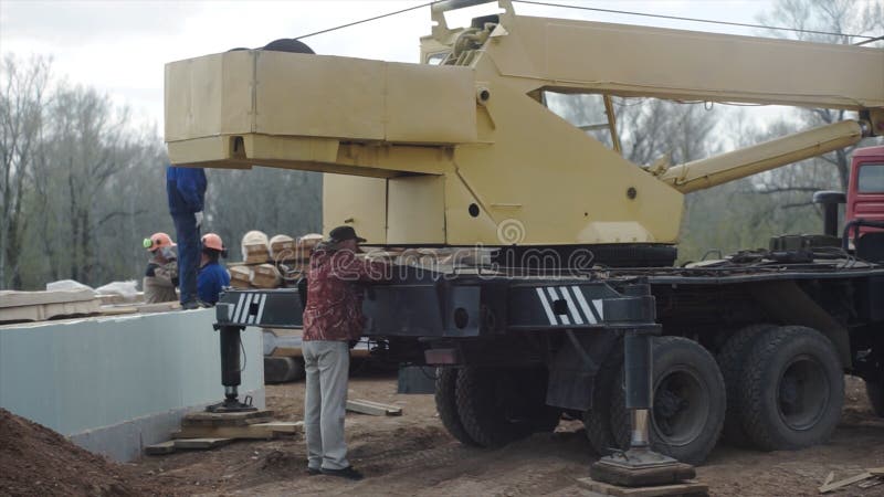 Construction site crane is lifting for building house. Clip. Crane for building a house stock image