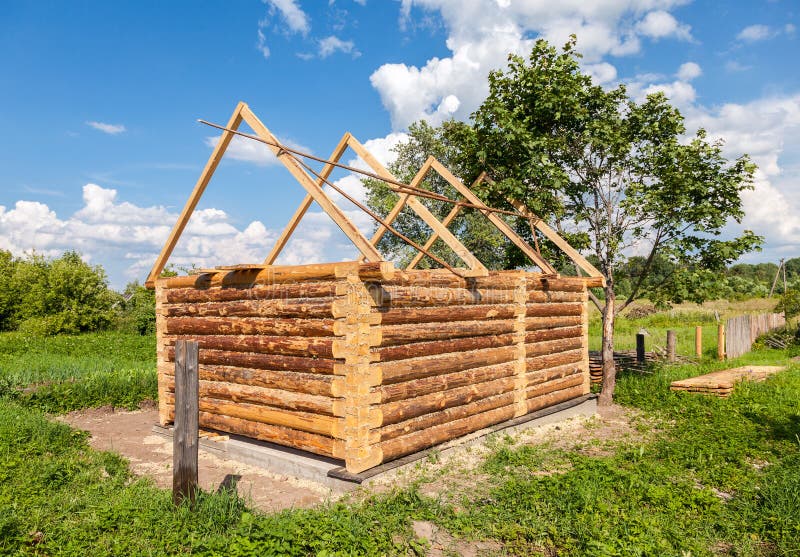 Construction of wooden bath house in Russian village. Construction of a new wooden bath house in Russian village royalty free stock image