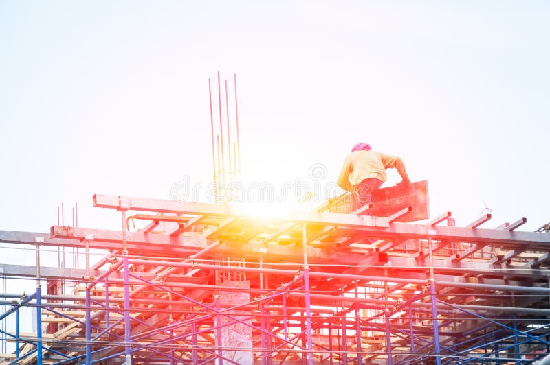 Construction worker during reinforcement work with metal rebar rods at building site royalty free stock photography