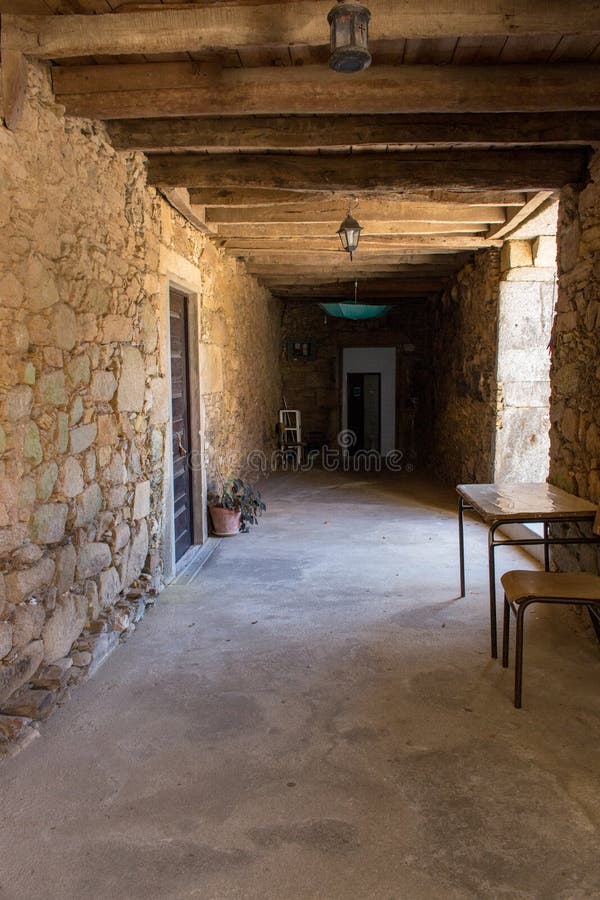 Corridor in medieval house with wooden beams on ceiling. Ancient stone building inside. stock photos