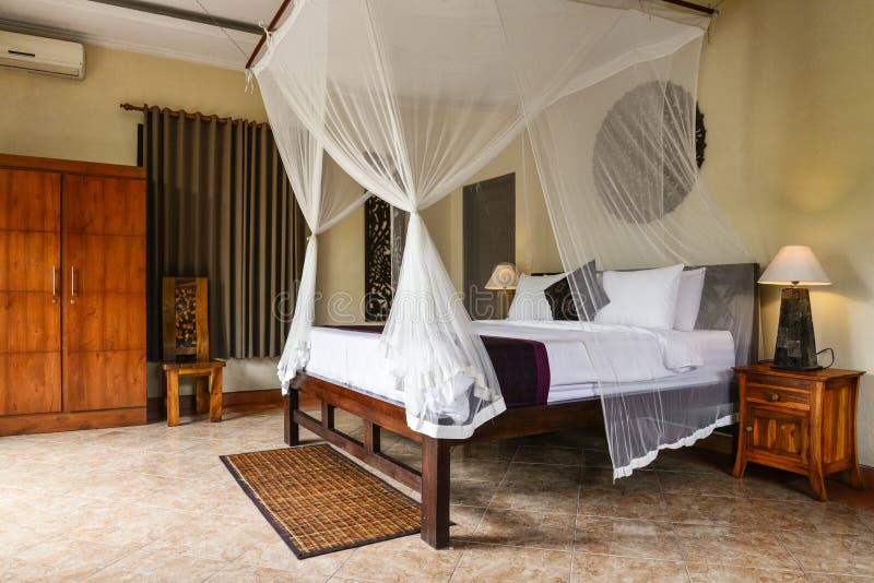 Cozy canopy bed in traditional balinese house. For rent, Ubud, Indonesia royalty free stock photography