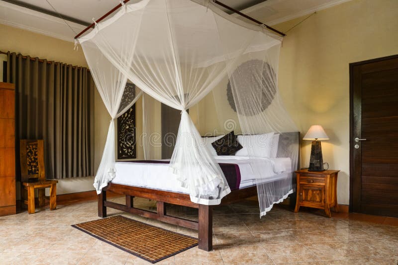 Cozy canopy bed in traditional balinese house. For rent, Ubud, Indonesia royalty free stock photos