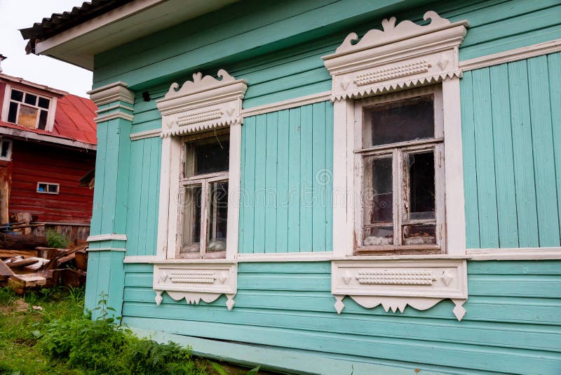 Russian traditional wooden house in the village, windows with carved platbands royalty free stock photo