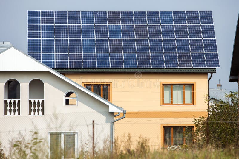 Facade of a private house with solar photo voltaic panels on roof stock photography