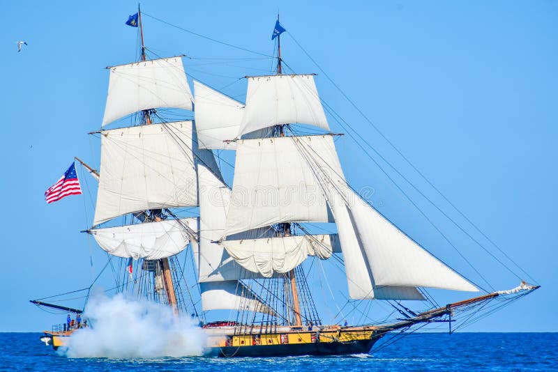 Tall Ships Parade On Lake Michigan in Kenosha, Wisconsin. The Flagship Niagara shooting a cannon is one of the most historically authentic tall ships in the royalty free stock images