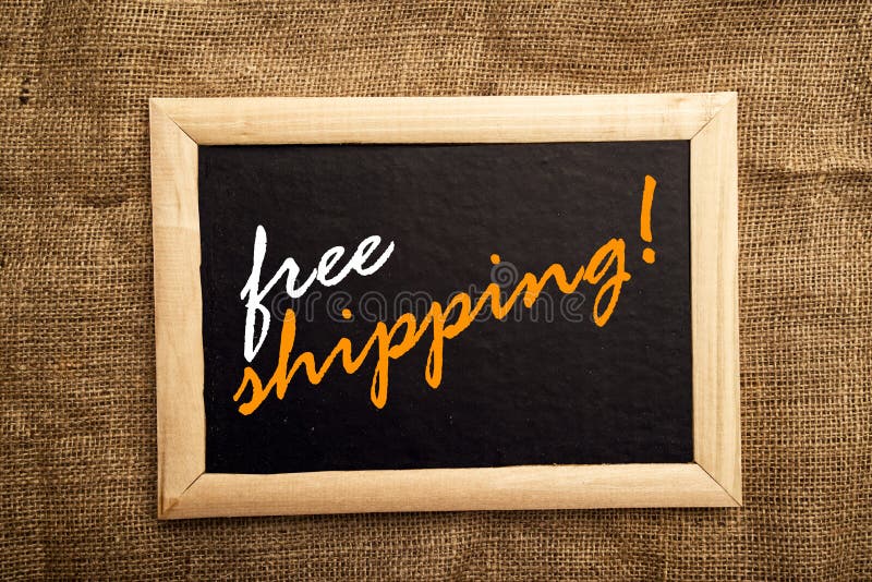 Free shipping. Note on black notice board royalty free stock photo