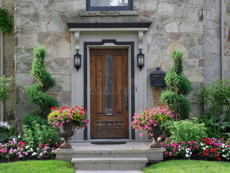 Front door with flowers. Suburban house stock photos