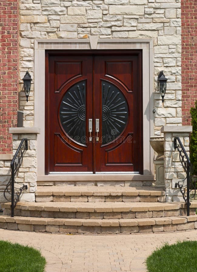 Front door. Mahogany brown wooden front door stock photo