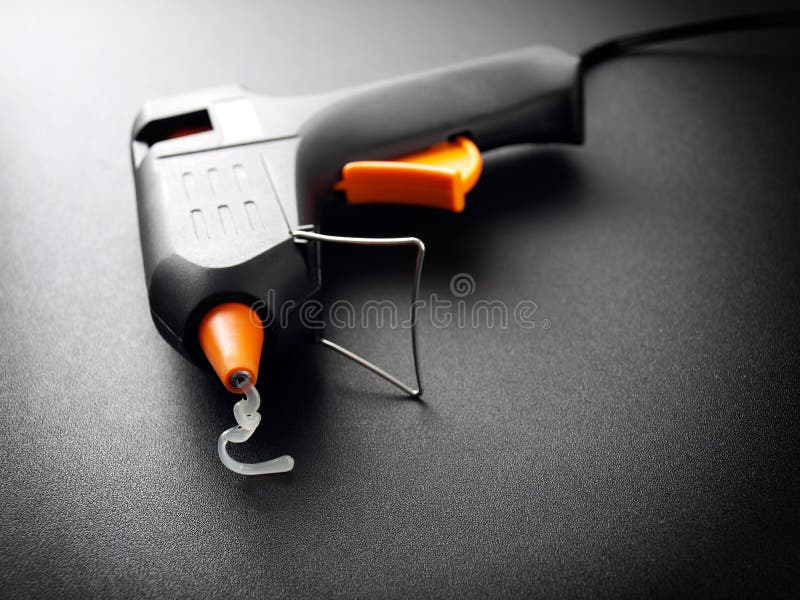 Glue gun. Closeup view of a modern electric glue gun stock images