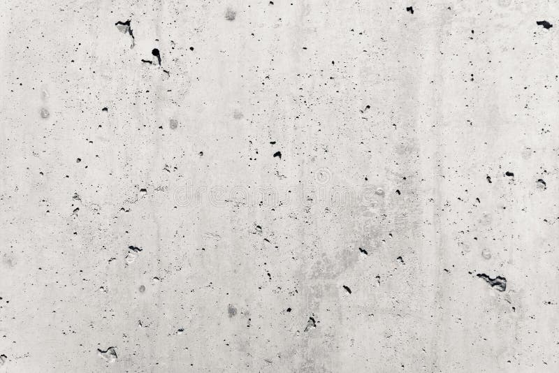 Concrete wall as gray coarse facade made of natural cement with holes and imperfections empty rustic texture concrete background royalty free stock photos