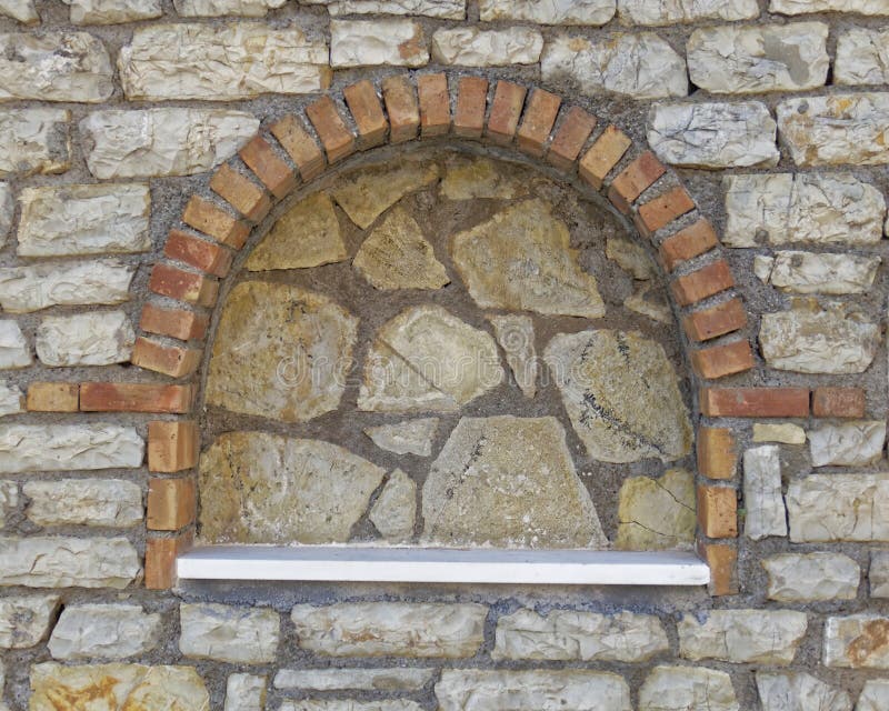 Greece, traditional arched decoration recess on stone wall. Greece, traditional arched bricks and marble self decoration recess on stone wall royalty free stock image