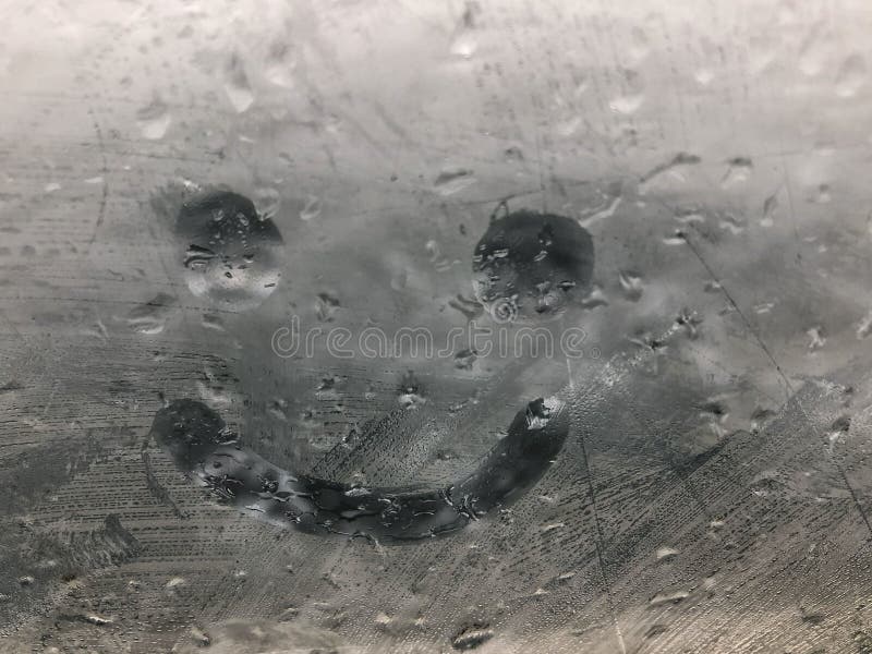 Hand drawn smiley icon on the misted window pane stock photo