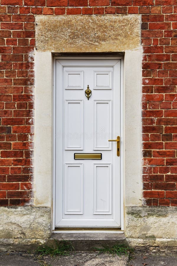 House Front Door. View of a White Front Door of a Red Brick English Town House stock images