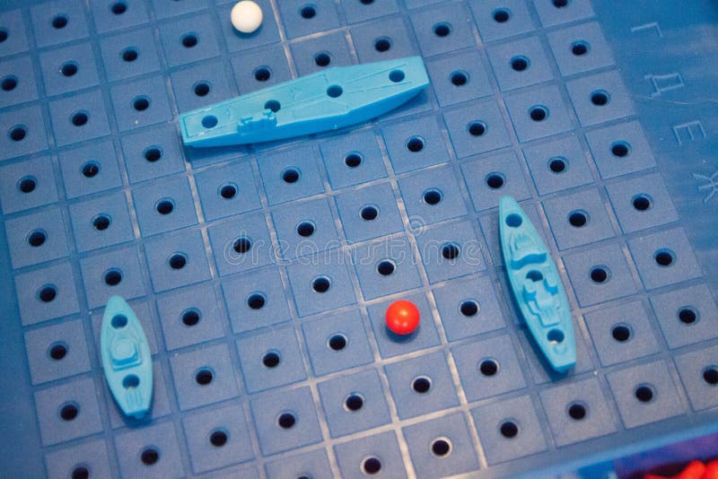 Image board game sea battle with a playing field and plastic figures of ships and marks on the battlefield.  stock photos
