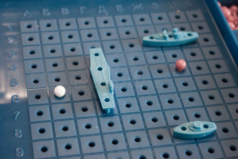 Image board game sea battle with a playing field and plastic figures of ships and marks on the battlefield.  royalty free stock photo