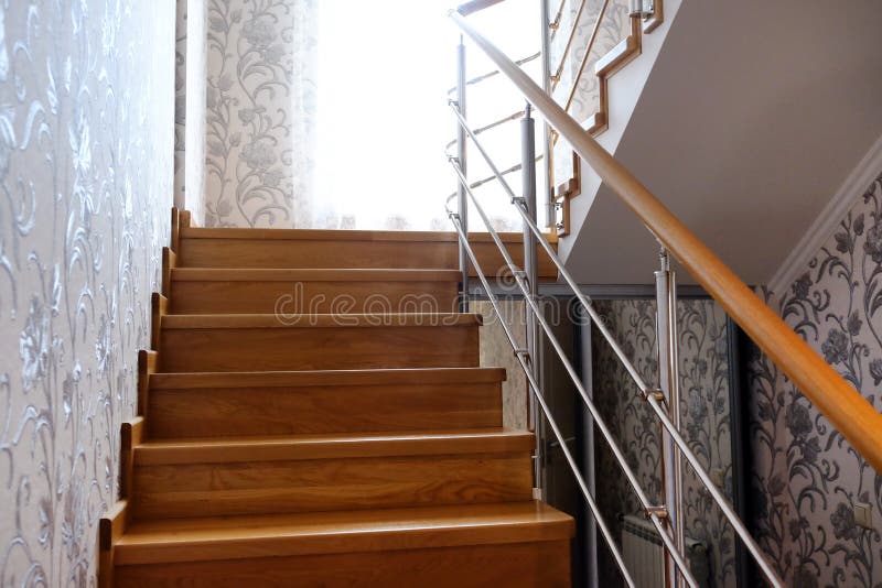 Interfloor stairs from the valuable breeds of wood for the cottage. Wooden staircase to the second floor. Modern wooden staircase royalty free stock photo