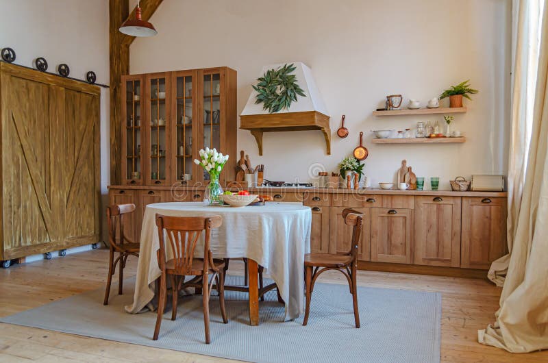 The interior of the kitchen in a rustic style, Scandinavian style. Wooden facades of cabinets. Nice sunny morning royalty free stock photos