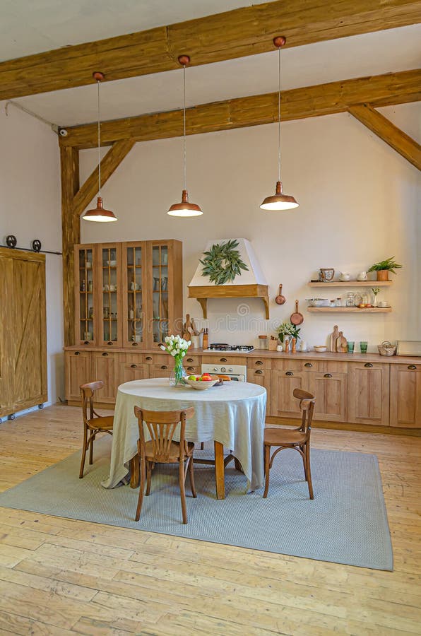 The interior of the kitchen in a rustic style, Scandinavian style. Wooden facades of cabinets. Nice sunny morning stock image