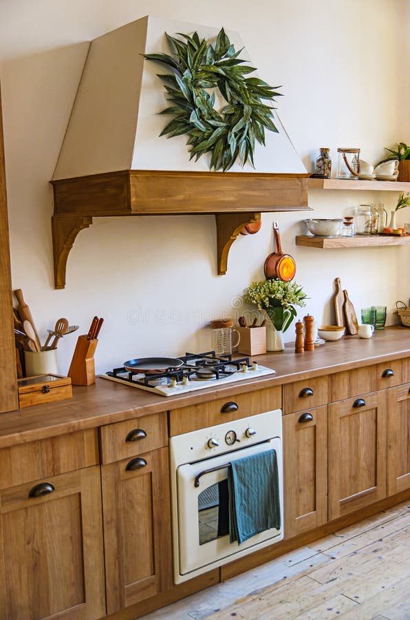 The interior of the kitchen in a rustic style, Scandinavian style. Wooden facades of cabinets. Nice sunny morning royalty free stock photography