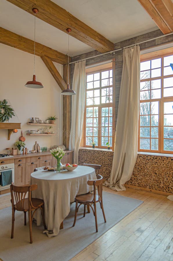 The interior of the kitchen in a rustic style, Scandinavian style. Wooden facades of cabinets. Nice sunny morning royalty free stock photo