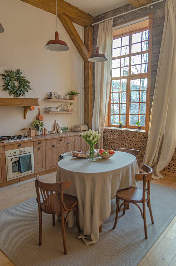 The interior of the kitchen in a rustic style, Scandinavian style. Wooden facades of cabinets. Nice sunny morning royalty free stock photo