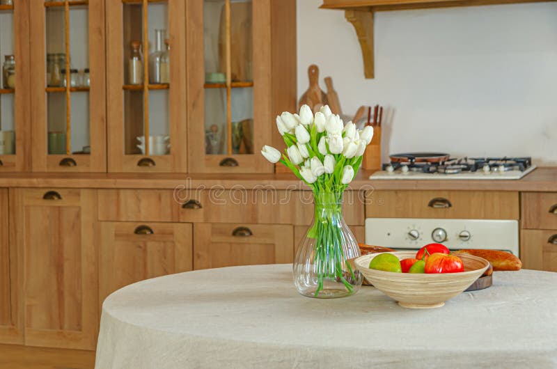 The interior of the kitchen in a rustic style, Scandinavian style. Wooden facades of cabinets. Nice sunny morning stock images