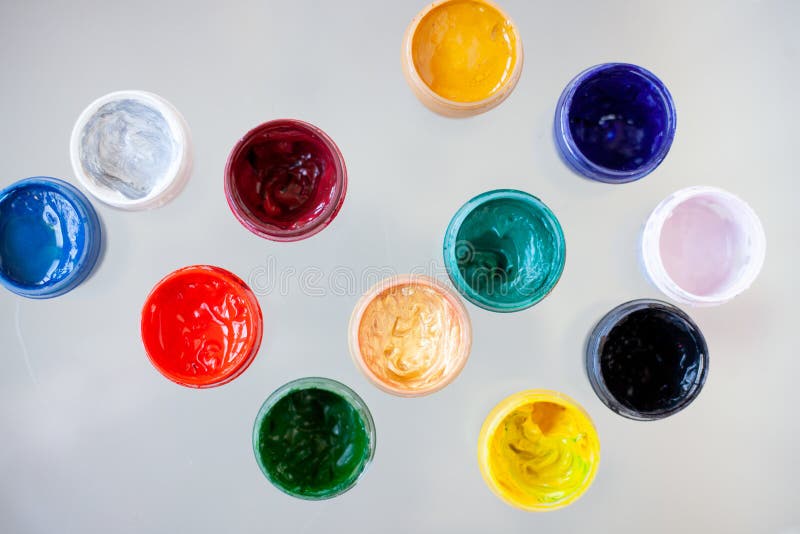 Jars of gouache on a glass table indoors royalty free stock photos