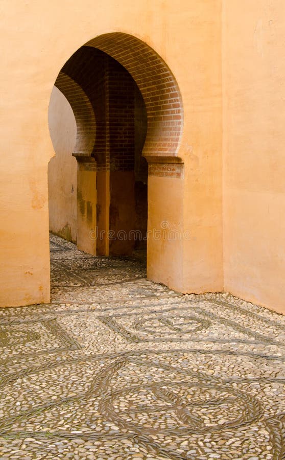 Keyhole arch doorway in ancient Spanish building stock photo