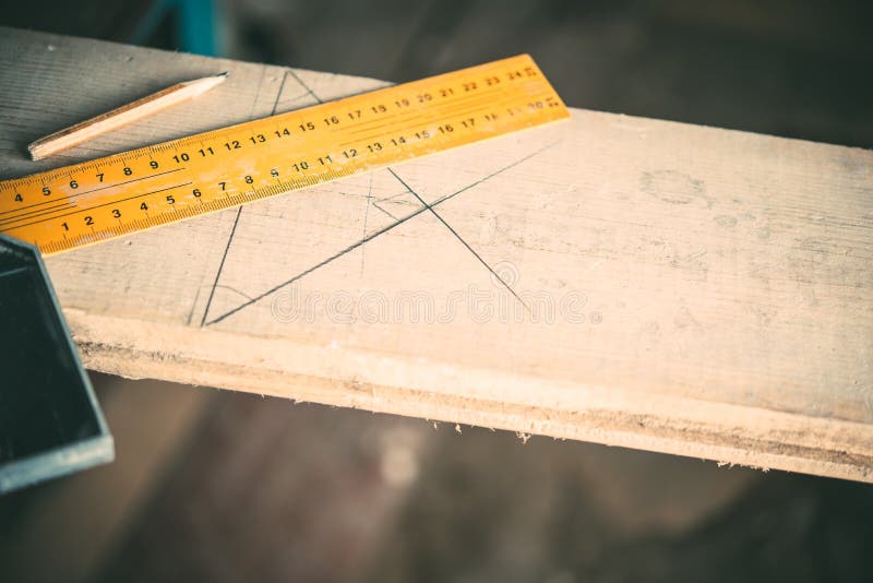 Length measurement using a metal ruler-corner on a wooden Board,carpentry.  stock photography