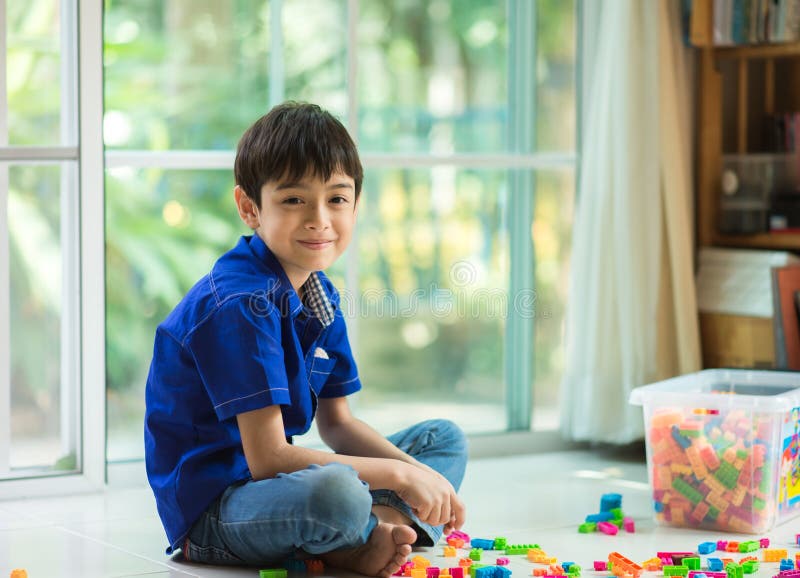 Little boy playing block indoor house stock photo