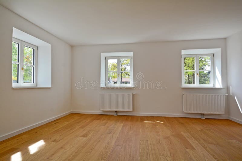 Living room in an old building - Apartment with wooden windows and parquet flooring after renovation stock photography