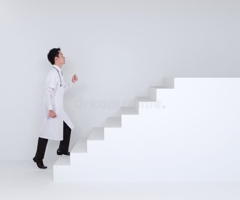 Male doctor stepping up on stairs royalty free stock photos