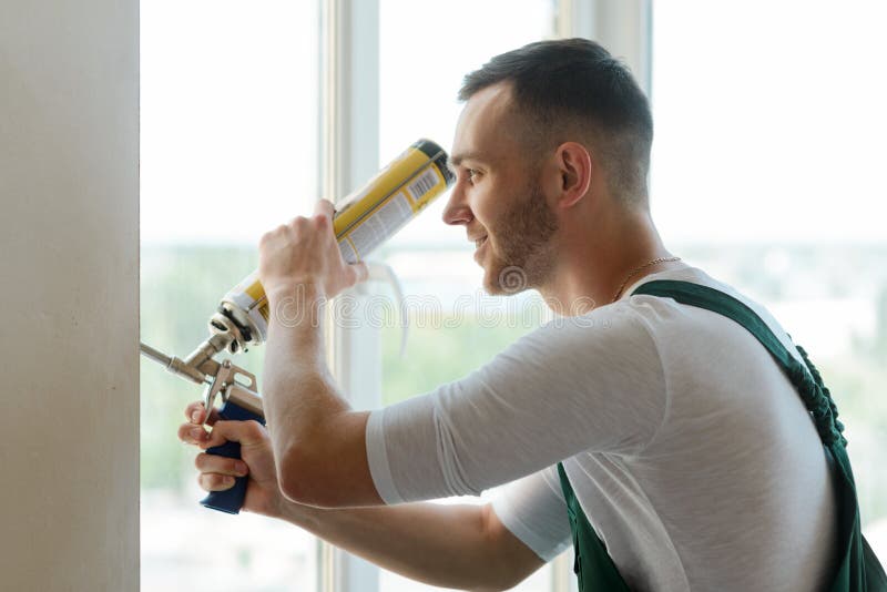 Man using polyurethane foam royalty free stock photography