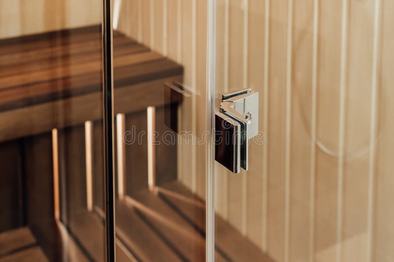 Metal fastening for glass walls in a sauna and a shower cabin. View in the interior royalty free stock images