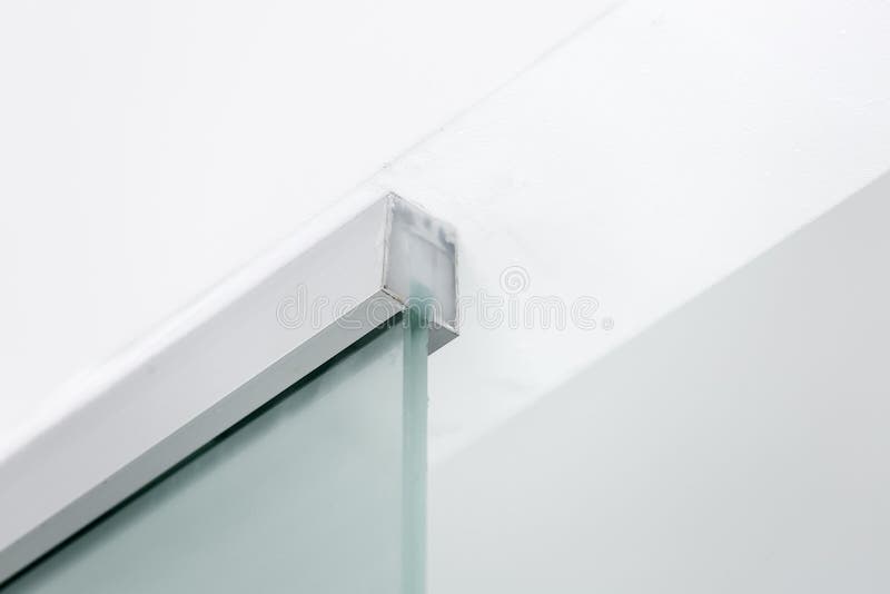 Metal fastening to the ceiling of a glass partition. Metal fastening to the ceiling of a glass partition, closeup of interior details royalty free stock images